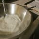 Combine flour, baking powder, 2 tablespoons sugar, and salt.