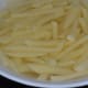 Immerse cut potatoes in salt water to remove excess starch