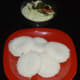 Idli served with raw mango chutney