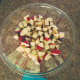Put apple pieces in a large mixing bowl.