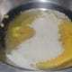 Step one: In a bowl, mix ghee, sugar, and water.