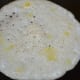 Step three: This is how you spread the batter on the griddle. You can see a few drops of ghee on it.