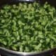 Step three: Add the chopped bitter gourd to the pan.