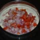 Step three: Add chopped tomatos and onion to the sauce.
