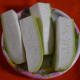 Remove the bottle gourd skin and cut the gourd in pieces for grating.
