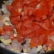 Step four: Add chopped tomato. Cook over high flame.