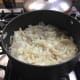 Onions cooking aware in their pot.