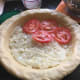 Adding a layer of tomatoes.