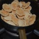 Take out some of the dried fritters and roast them on low fire. Sprinkle some oil on roasted fritters.