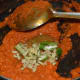 Step four: Stir-fry till the mix leaves oil on the edges. Throw in julienned ginger and slit green chili. Continue simmering.