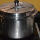 Step seven: Cover the cooker lid and cook on medium high fire till one whistle.
