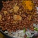 Step five: Add cooked beans, turmeric powder, jaggery powder, and salt. Mix well. Cook for 2 minutes.