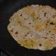 Step seven: Cook it on a hot pan, adding some oil or ghee