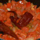 Step four: Saute tomato and soaked red chilies.