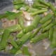 Step 2: Sauté onion in ghee and oil mix in a pressure cooker bottom. Add chopped French beans. Stir-cook for a while.