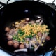 Peas and sweetcorn are added to wok