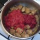Tomatoes and paste are added to turkey