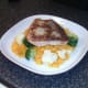 Salmon fillet is laid on bed of rice
