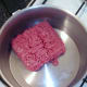 Beef is added to a dry pot for browning