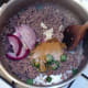 Spice ingredients are added to browned beef