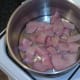 Chopped chicken is added to pot and seasoned