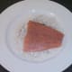 Salmon is patted in seasoned flour