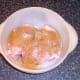 Turmeric and seasonings are scattered over chicken thighs