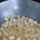 Add the peanuts. Over medium heat, stir continuously. Add optional chopped chilli pepper if you prefer it spicy.