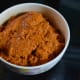 Step three: Take fried masala in a mixer or grinder. Add jaggery, tamarind pulp, and salt. Grind, adding water to get a thick, near-smooth paste.