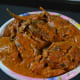 Step six: Close the lid, cook up to a whistle and simmer for 3 minutes. Turn off the fire. Place the stuffed eggplant curry in a bowl once the pressure comes down.