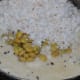 Step four: Add warm water little by little and completely immerse the semolina. Add salt, parboiled beans, and grated coconut.