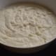 Step 3: Add water and mix to get the required batter consistency. Add the fruit salt and give a quick stir. Pour the batter into the greased idli moulds and steam-cook them for 10 minutes.