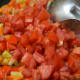 Step seven: Add tomatoes and continue to cook.
