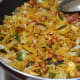 Step nine: Ensure the fine mixing of the spices and seasonings with the rice flakes. Poha chivda is ready to munch.