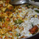 Step eight: Return rice flakes to the pan little by little and gently mix, so that they don't break. Turn off the fire.
