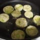 add coated tomatoes to hot oil