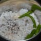 Step 2: Grind grated coconut, mustard seeds, and green chilies, adding water to get a smooth paste.