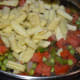 Step six: Add parboiled baby corn. Stir-cook till baby corn gets completely cooked with the other veggies.