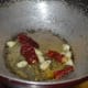 Sauté mustard seeds, garlic, and broken dry red chilies in oil. Let the mustard crackle.