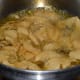 Step five: Heat oil for deep frying. Press or turn the ribbon pakora maker handle. Drop the dough ribbons into the hot oil. Fry both sides till golden brown.