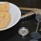 Step three: Keep ready the dough and the instrument/press for making ribbon pakoras. Apply oil inside the hollow pakora maker container.