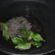 Step three: Heat oil in a deep-bottomed pan. Add mustard seeds and curry leaves. Let mustard crackle.