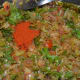 Step seven: Add red chili powder. Mix the contents. Stir-cook for a while.