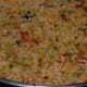 Step eight: Add cooked rice. Combine with the veggies and the spice mix. Pour a teaspoon of ghee. Turn off the fire after stir-cooking for a minute.