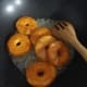 Quickly, add the donuts into the sugar syrup.