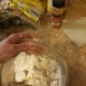 Slowly cut butter into dry ingredients until it begins to crumble.