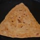 Step eleven: Remove and place it on a plate. Make all the parathas like this.