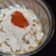 Step one: Take wheat flour, red chili powder, salt, carom seeds, and oil in a mixing bowl. Mix them. Knead while adding water little by little, to get a smooth and pliable dough.