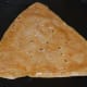 Step ten: Let the bottom side get golden brown spots. Flip it now. Add a few drops of ghee on top. Cook the other side also till golden brown.