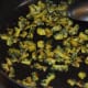 Continue sautéing for up to 7–8 minutes on low fire. By this time, the bitter gourd Should have shrunk and become almost dry. Turn off the fire and put aside for cooling.